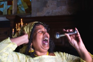 Closeup of a mature gospel or soul singer in a dark church