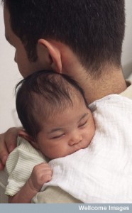 N0026869 A father holds his sleeping baby