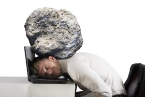 Concept of stress with businessman with a rock on the head